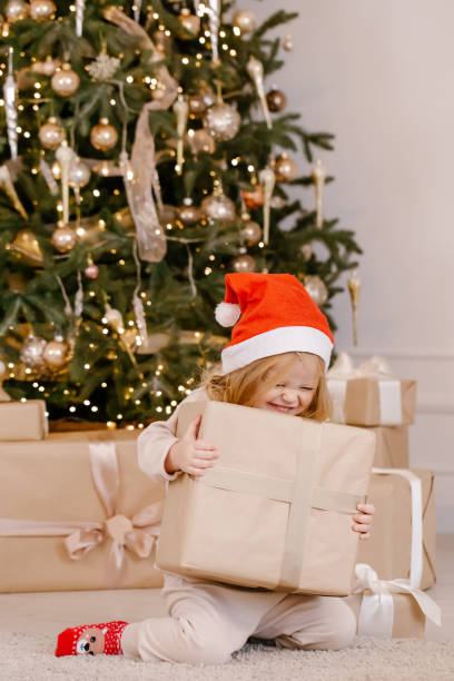 istock Child in Santa hat with Christmas gift 1288724125