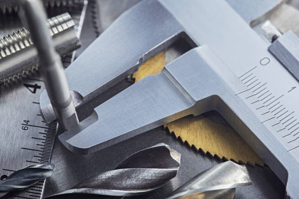 istock Measuring with vernier caliper thread tap for locksmitning work on steel plate. Locksmithing workshop. 1288724881