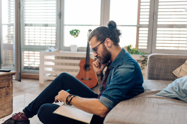 istock Young man making a business call from his living room 1288728680
