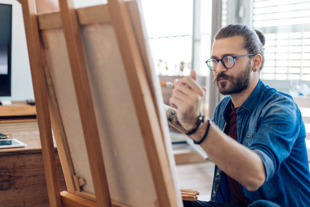 istock Young artist working on a new canvas at home 1288728831