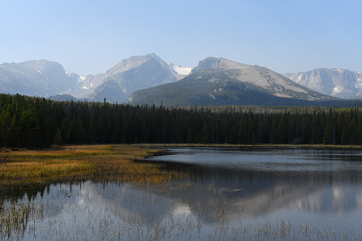 Rocky Mountains in a haze of nearby 2020 wildfires above the Bierstadt Lake, Rocky Mountain National Park, Colorado.