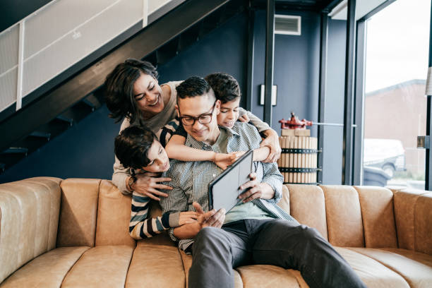 istock Family with two kids at home during the lockdown having online communication 1288730555
