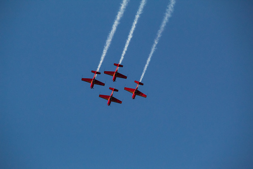 Matilla, Spain – April 22, 2023: A small aircraft in the sky with fluffy white clouds as a backdrop