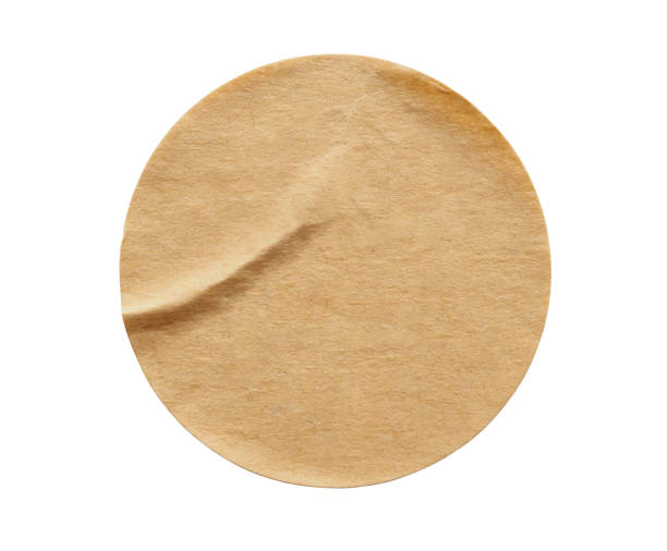 istock Brown round paper sticker label isolated on white background 1288731867
