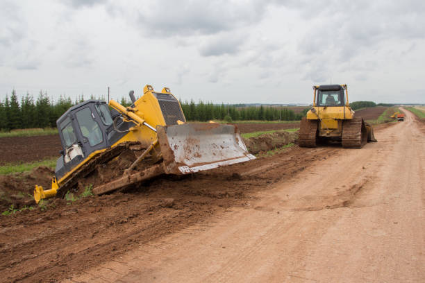 istock Bulldozer during road construction. Construction machinery. Earth moving by a bulldozer in the construction of a road. Excavator on a construction site of a road 1288732050