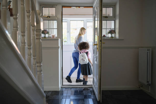 istock Mother and elementary age daughter leaving for school 1288732072