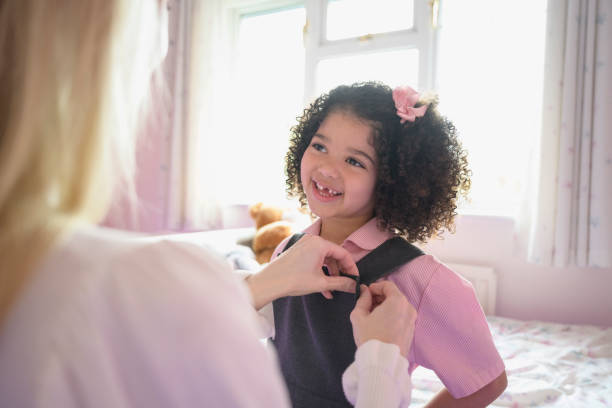 istock Elementary age mixed race girl getting dressed for school 1288732100
