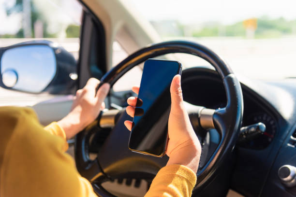 istock woman inside a car and using a hand holding mobile smartphone 1288740163