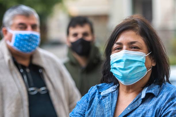 Overweight hispanic or middle eastern senior couple and their son wearing  protective masks due Covid-19 pandemic Overweight hispanic or middle eastern senior couple and their son wearing  protective masks due Covid-19 pandemic fat mexican man pictures stock pictures, royalty-free photos & images