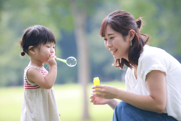istock Parents and children playing with soap bubbles 1288744964