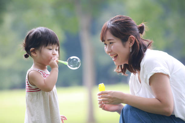 istock Parents and children playing with soap bubbles 1288745017