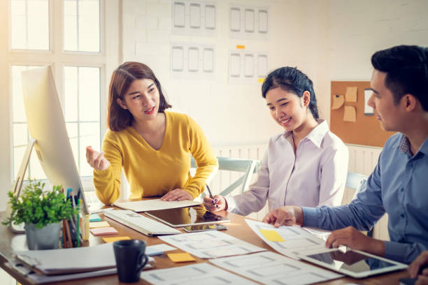 istock Group of Young asian Designers drawing website ux app development on mobile phone. 1288746256
