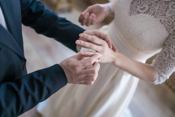 istock Wedding rings and hands of bride and groom. 1288755076