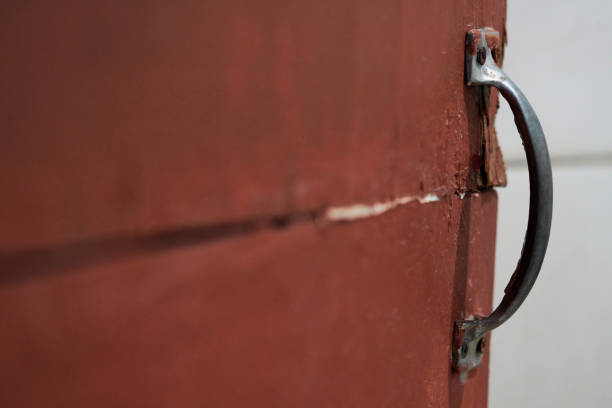 istock old door handle on red door 1288755166