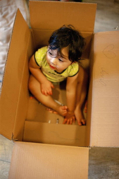istock Quarantine Baby Girl Playing In Cardboard Box 1288760165