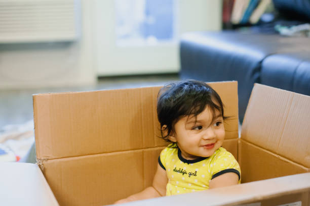 istock Quarantine Baby Girl Playing In Cardboard Box 1288760167
