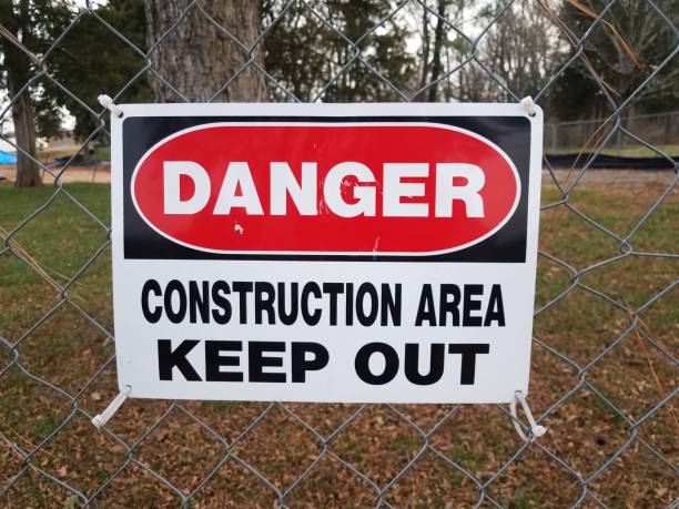 istock danger construction area keep out sign on fence 1288760315
