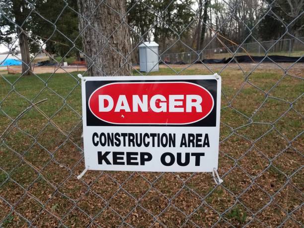 istock danger construction area keep out sign on fence with outhouse 1288760328