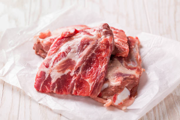 Raw spare ribs on white background, ready for cooking
