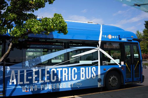 Tigard, OR, USA - May 5, 2020: An all-electric bus wind-powered by PGE is seen at the Washington Square Transit Center in Tigard, Oregon. Portland General Electric (PGE) is a public utility.