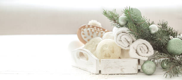Spa composition with Christmas decoration on light blurred background copy space.