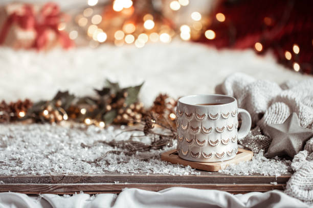 istock Cozy winter background with a beautiful cup on a blurred background with bokeh. 1288774906
