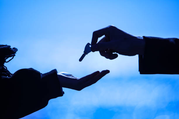 A man handing a key to a woman