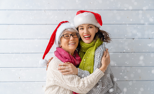 Merry Christmas and Happy Holidays! Winter portrait of loving family on white wooden background.