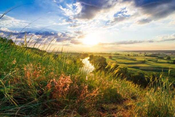 istock A beautiful valley with a river, blue sky with large clouds and bright sun. Aerial 1288777756