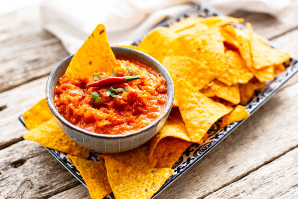 istock Nachos with salsa sauce on a plate on wooden table 1288780043