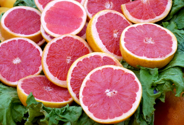 istock Heap of grapefruit chopped halves 1288780188