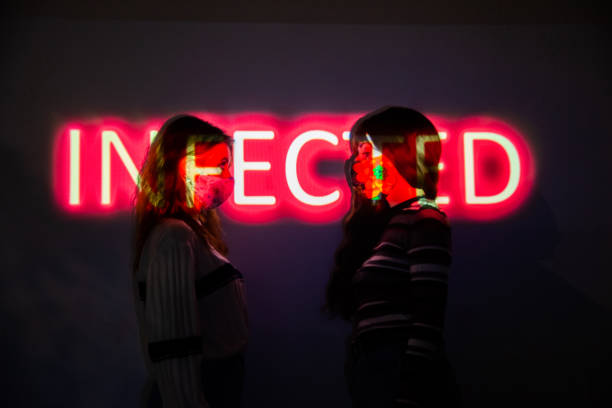 istock Two women by the wall with the infected message projected onto their bodies 1288785918