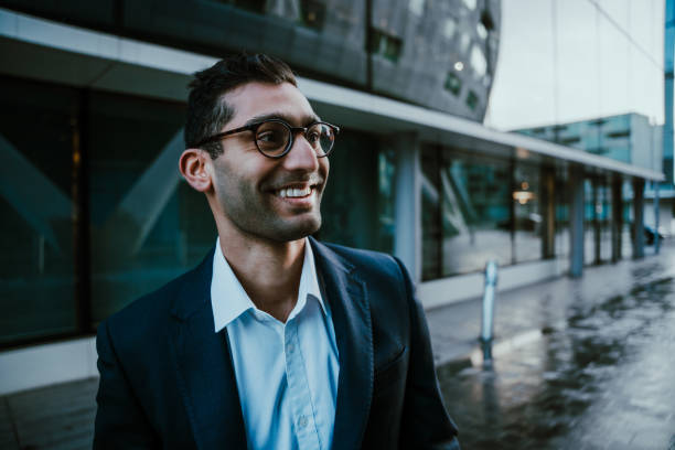 istock Mixed race businessman smiling walking to work before conference meeting 1288787267