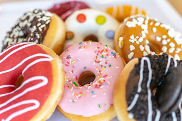 istock Tasty donuts on a white tray close up 1288787505