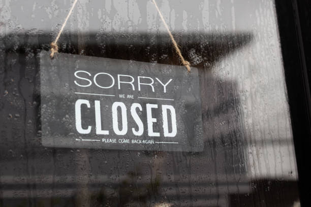 istock Sorry we're closed sign. grunge image hanging  on a rainy day. 1288788310