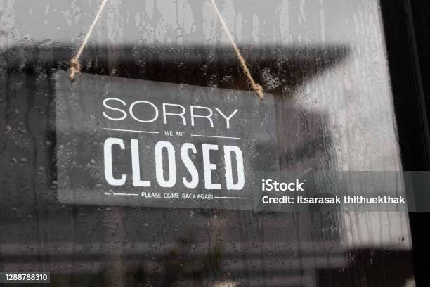 Sorry Were Closed Sign Grunge Image Hanging On A Rainy Day Stock Photo - Download Image Now