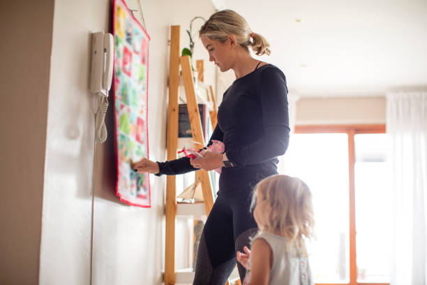 A mother and her daughter filling an advent calendar with chocolate. A mother and her daughter filling an advent calendar with chocolate at their home in Gordon's Bay, South Africa. gordons bay stock pictures, royalty-free photos & images