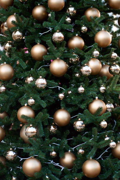 istock Green christmas tree decorated with golden balls. 1288795230