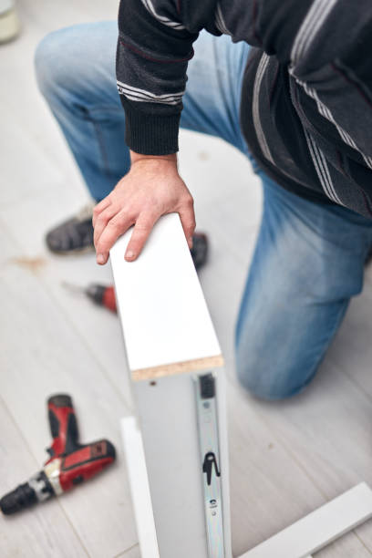 istock Handyman worker assembling furniture and fixing it. 1288795931