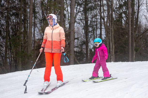 istock The child is skiing with his mother. 1288797616