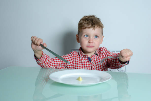istock Diet for a little boy who is hungry on the kitchen 1288799008