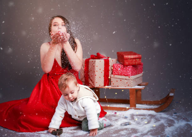 Baby boy and young woman with Christmas decoration