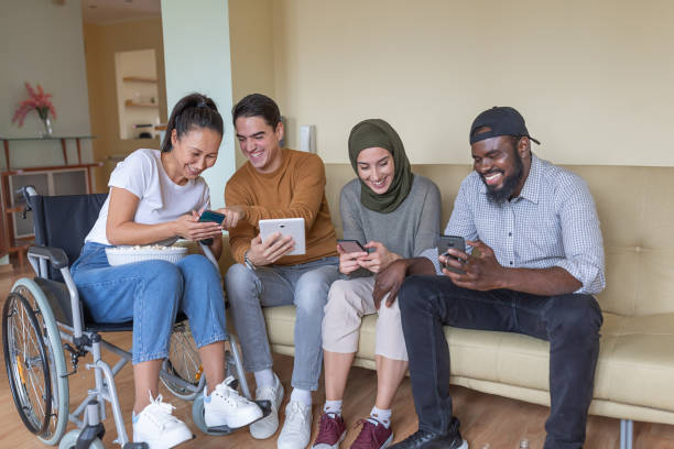 istock Happy Group of Young Multicultural Friends are Hanging Out at Home While Using Their Digital Devices. 1288799826