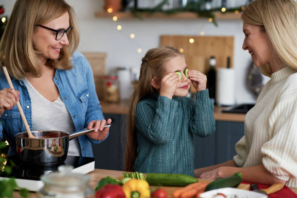 istock Little girl playing with cucumber in the kitchen 1288800932