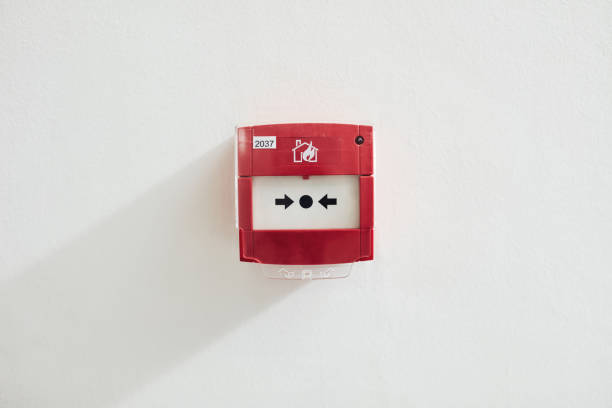 Fire alarm device that installed on building wall, press the button to activate sound in emergency fire case. Safety equipment object photo, close-up.