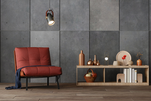 Interior Of Modern Living Room With Red Armchair, Decorative Objects On The Cabinet, Gray Colored Wall And Parquet Floor