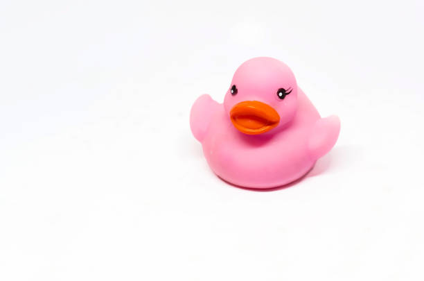 istock Pink rubber duck with orange beak isolated on a white background. 1288801811