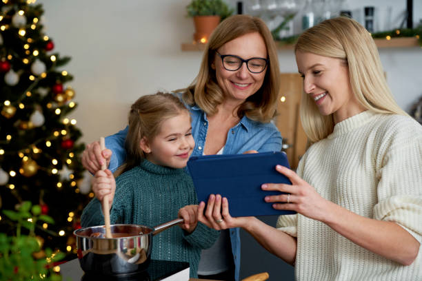 istock Three generations of women using a tablet in the kitchen 1288802327