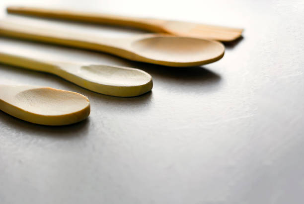 istock Group of wooden kitchen spoons arranged on a gray marble table 1288802380