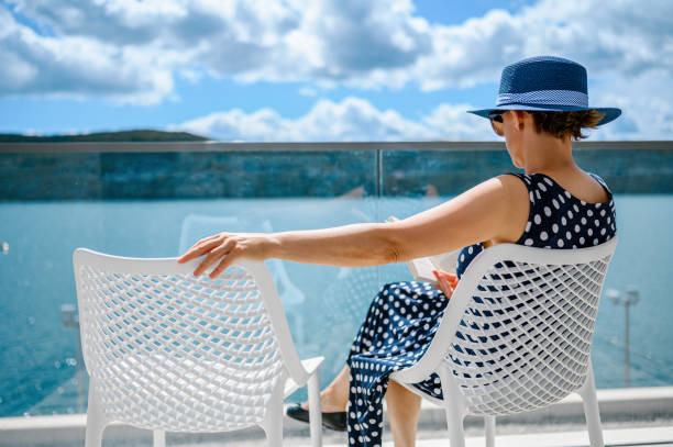 istock Woman enjoying the balcony and reading a book 1288802878
